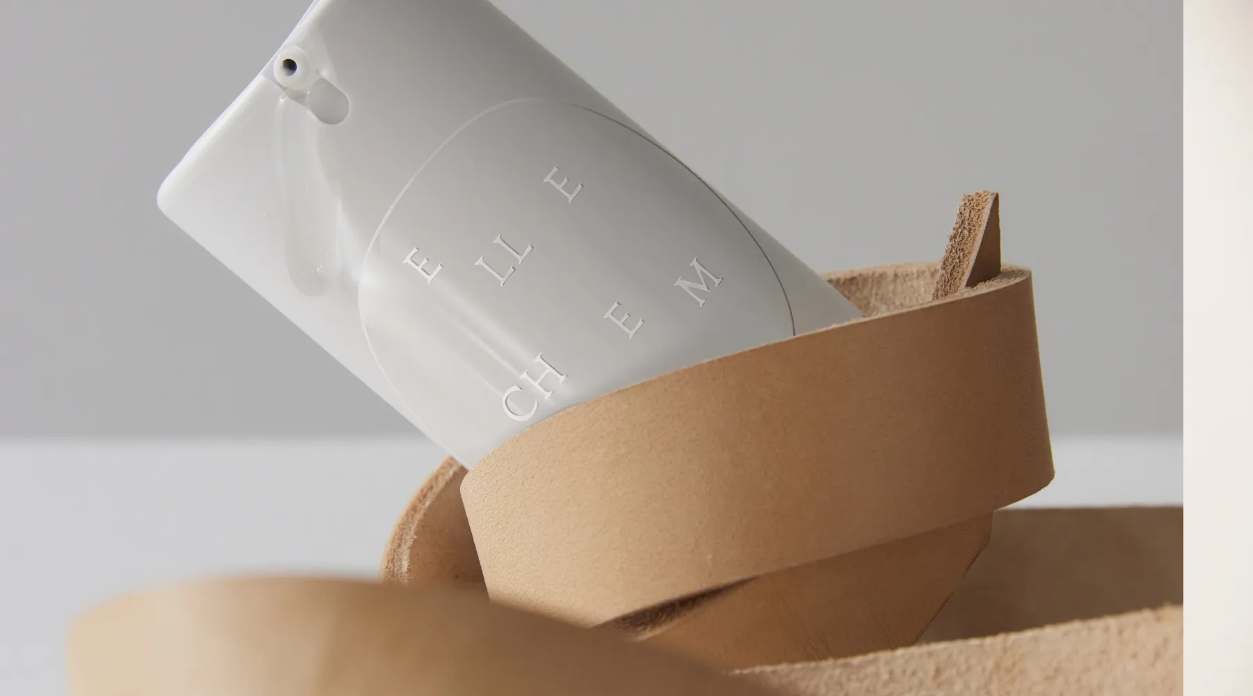 Elle Chem pump bottle resting in a tan leather loop — shop at Lovers Products
